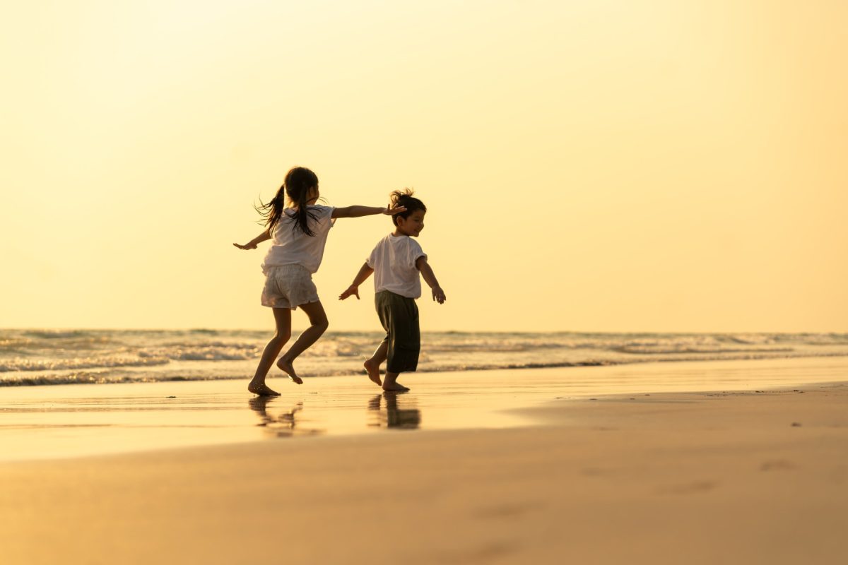 kids running on the beach