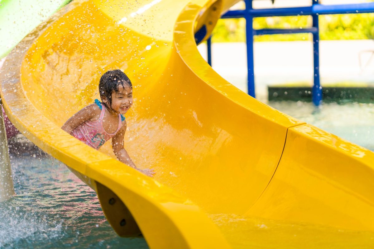 little girl on yellow waterslide