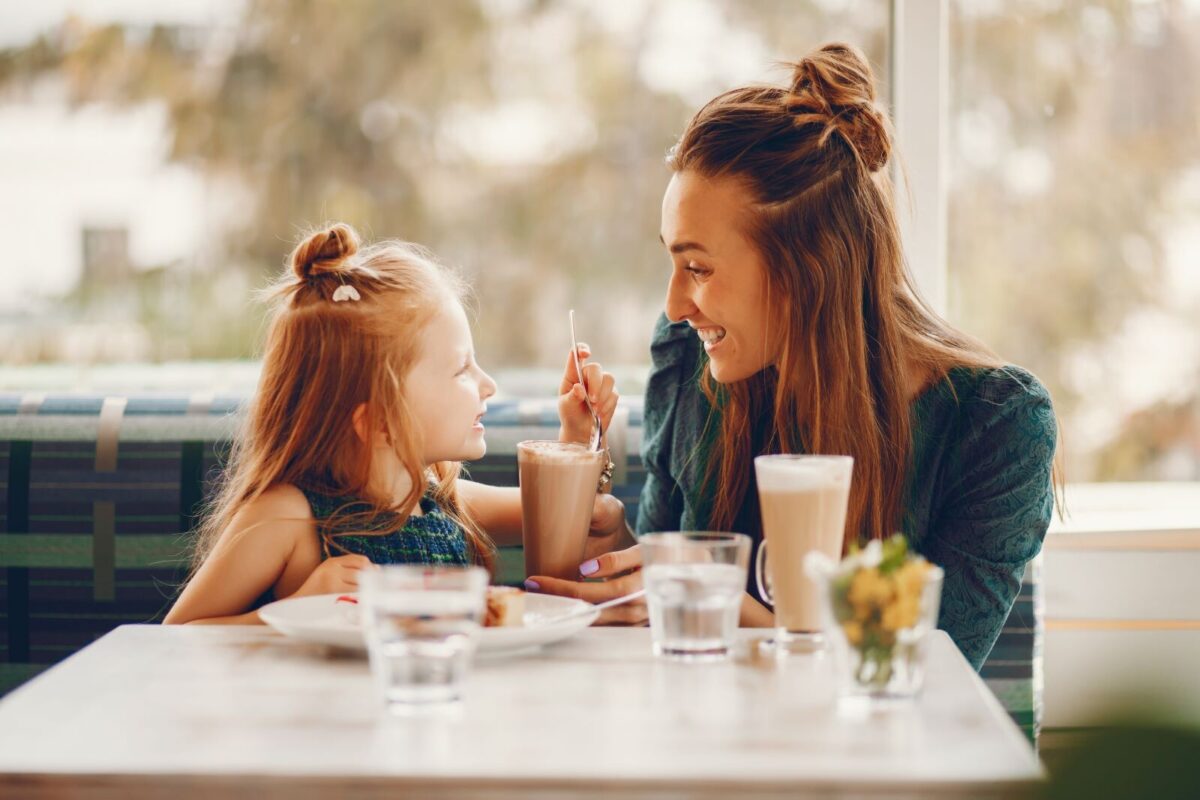 mom and daughter eating at breakfast restaurant