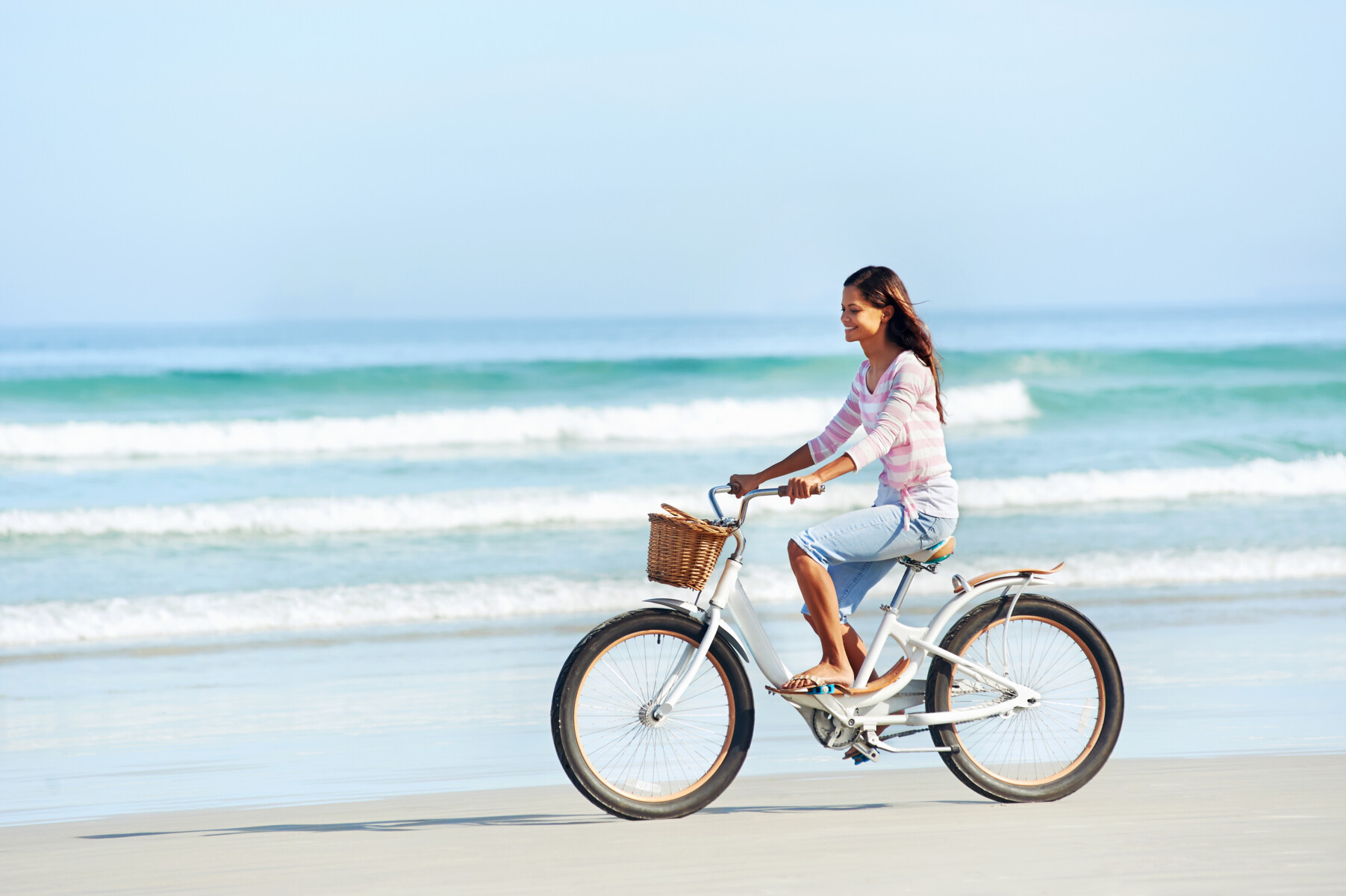 woman riding bike on beach