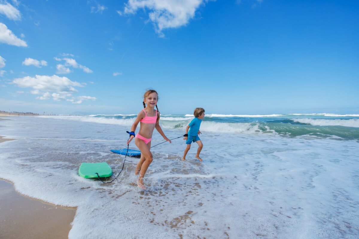 kids running with bodyboards