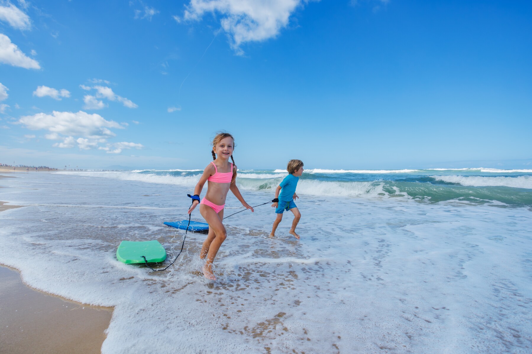 kids running with bodyboards