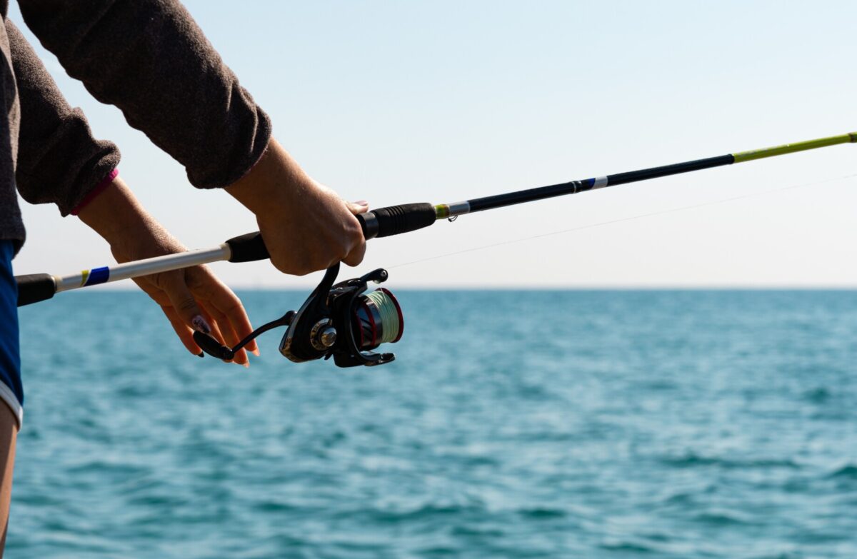 up close shot of person fishing on water