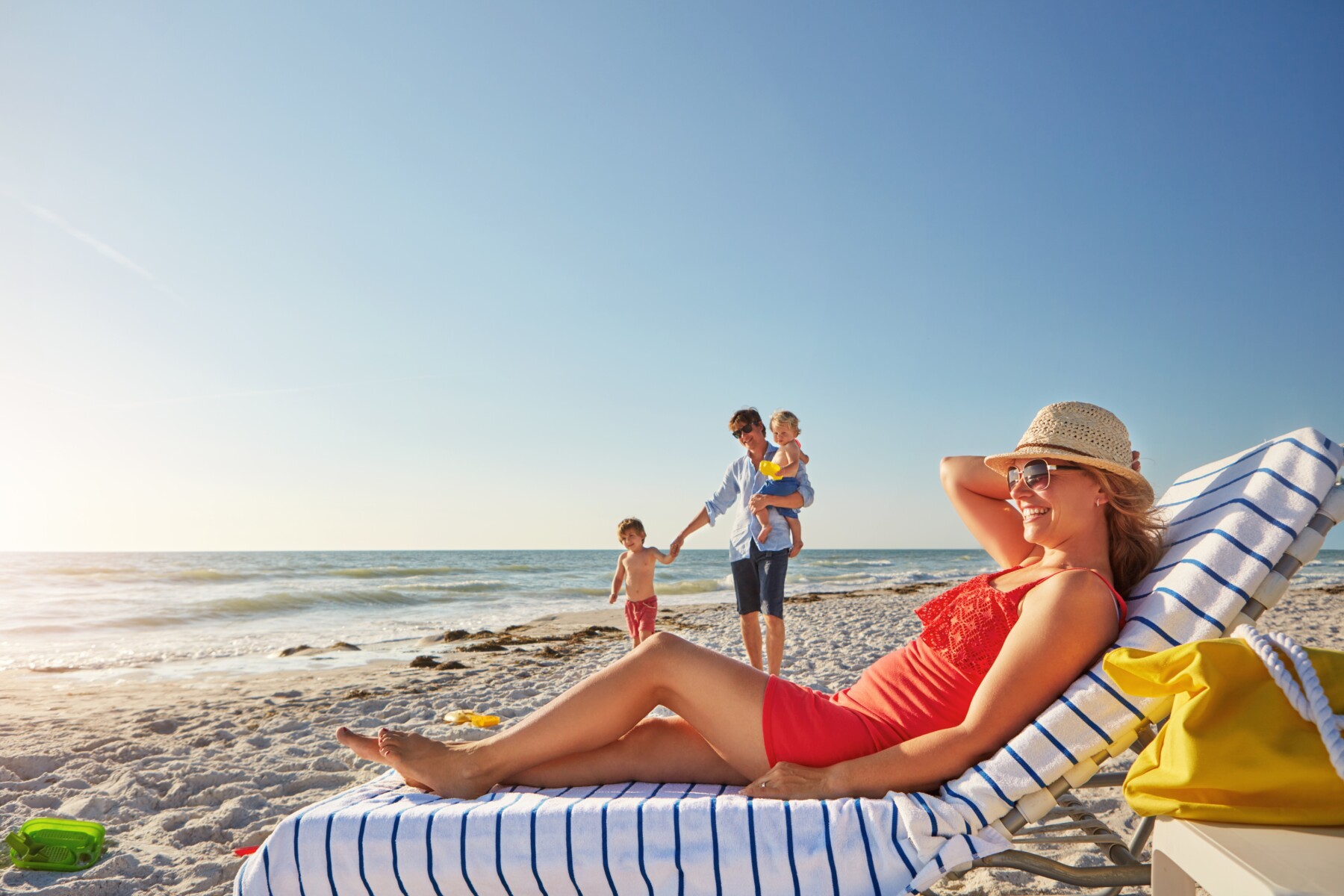 family relaxing on beach